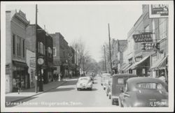Downtown Street Scene with Classic Cars and Storefronts Postcard