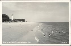 Beach Scene with Lighthouse and Swimmers Postcard
