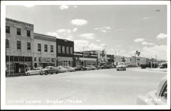 Downtown Street Scene with Dunlap's Storefronts & Cars Postcard