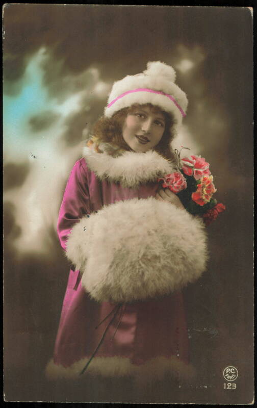 Young Woman in Winter Fur Hat and Coat with Flowers