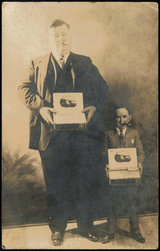 Tall Man and Short Man Holding Meditation Cigar Boxes Memphis Tennessee