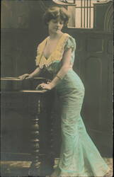 Woman Leaning on Table with Guitar Postcard