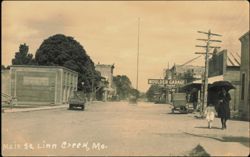 Main Street Scene with Moulder Garage Postcard