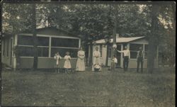 Family Posing in Front of Two Screened-In Cabins Postcard