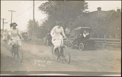 Women Riding Bicycles on Dirt Road in Tarkio, Missouri Postcard
