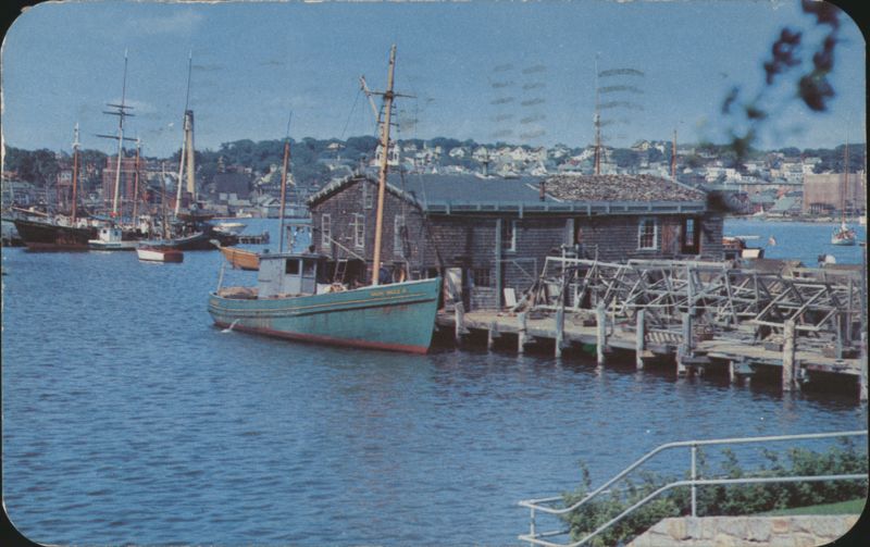 A typical harbor scene showing fishing boats and net drying racks Gloucester Massachusetts