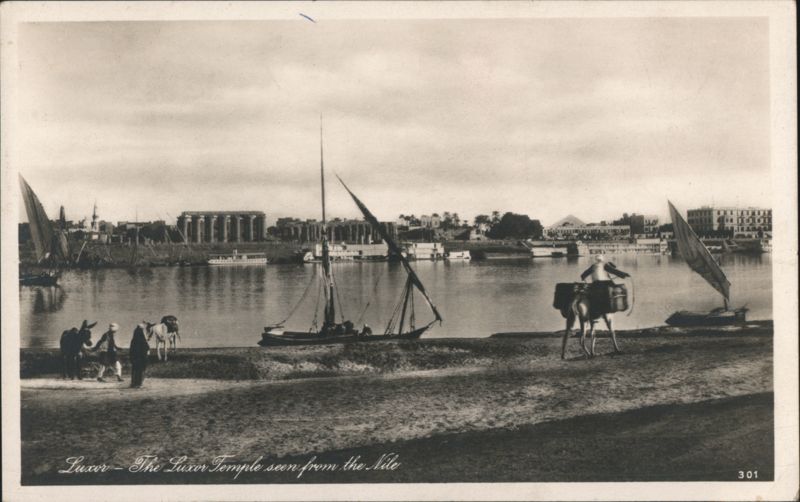 Luxor Temple seen from the Nile with boats & camels Egypt