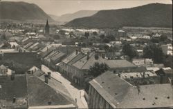 Rožňava City View with Church Spire and Mountains Postcard
