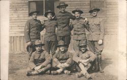 9 Soldiers in Uniform Group Portrait WWI Era Camp Barracks Postcard