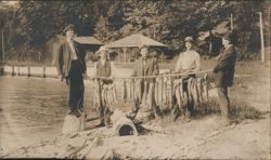 Men Displaying Large Fish Catch by Lake Postcard