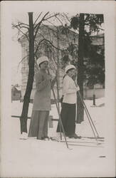 Two Women Skiing in Snowy Park, Winter Attire Postcard