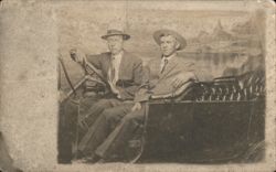 Two Men in Hats in Early Automobile, Newton IA Postcard
