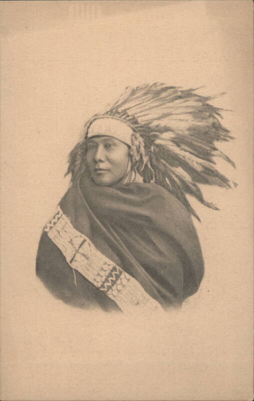Native American Man in Feathered Headdress and Patterned Blanket