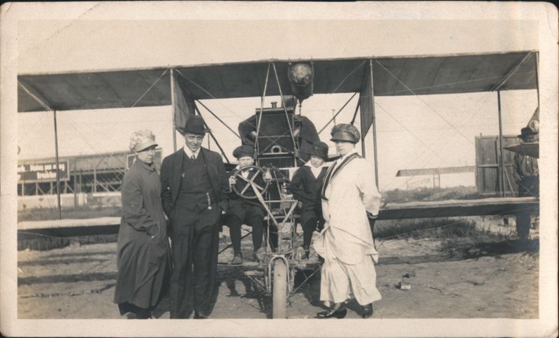 Early Biplane with Group & Boys in Cockpit at Airfield