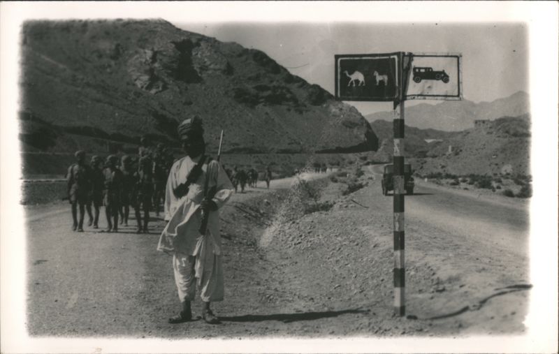 Torkham Border, Khyber Pass Armed Sentry, Soldiers & Camel/Car Sign in Mountain Pass Pakistan
