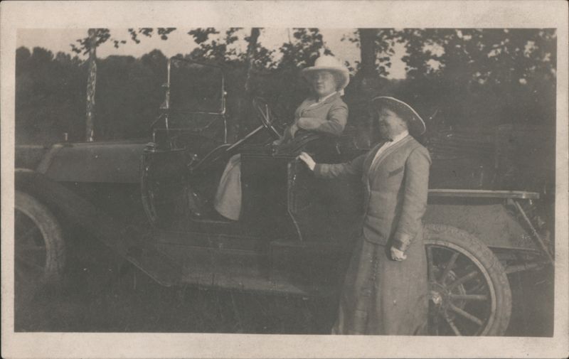 Two Women Posing with Early Automobile Touring Car