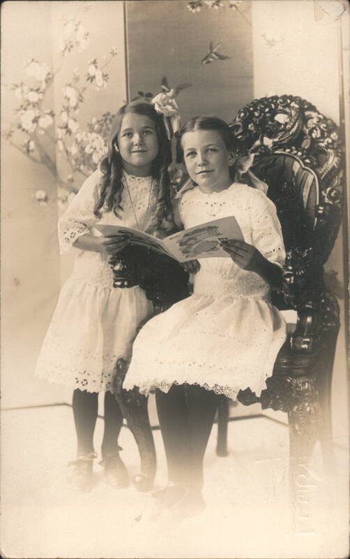 Studio Portrait Two Girls Reading Book Ornate Chair