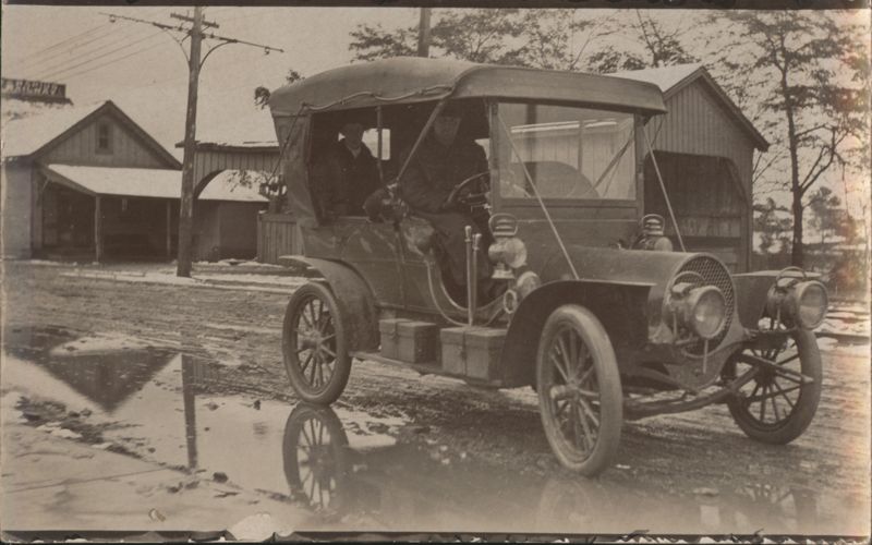 Early Automobile Touring Car on Muddy Winter Street