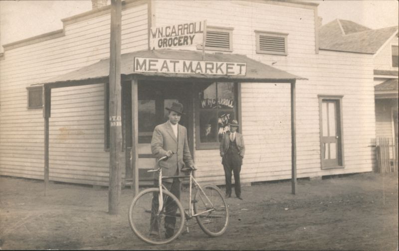 W.N. Carroll Grocery & Meat Market Storefront, Man with Bicycle