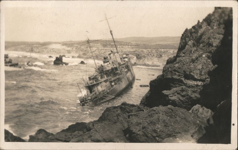 Shipwrecked Naval Destroyer Stranded on Rocky Coast