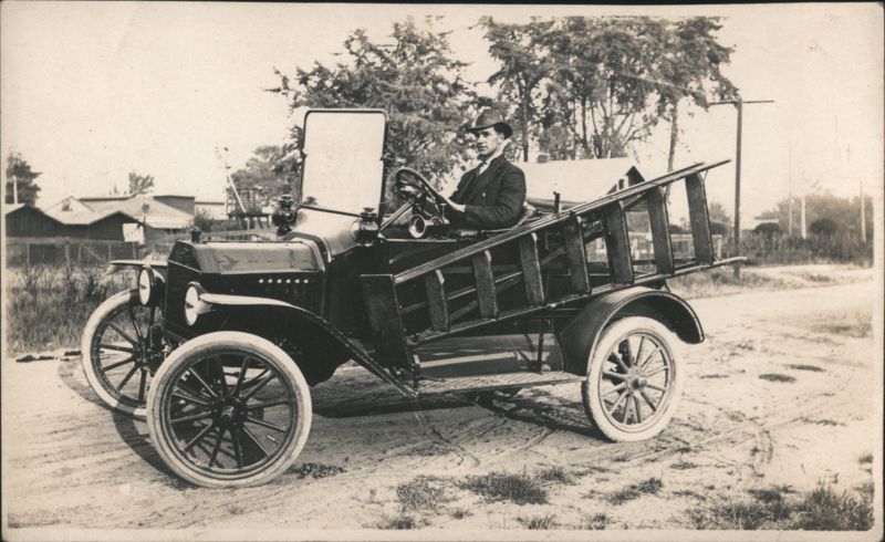 Man Driving Early Ford Model T with Wooden Ladder Transportation