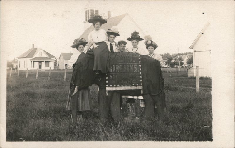Group Posing on Advertising Elephant Prop The Leader Store Clarinda Iowa