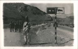 Armed Sentry, Soldiers & Camel/Car Sign in Mountain Pass Postcard