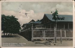 Hospital de Puntarenas Exterior with Airplane Overhead Postcard