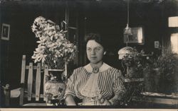 Young Woman in Striped Blouse with Vase of Lilies Portrait Postcard