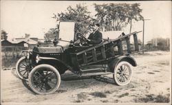 Man Driving Early Ford Model T with Wooden Ladder Postcard