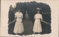 Two Women in White Dresses on Wooden Footbridge Postcard