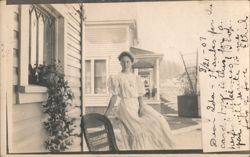 Woman in White Dress Sitting on Porch Railing 1907 Postcard