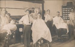 Barber Shop Interior with Three Barbers and Customers Postcard