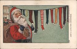 Santa Claus with Stockings on a Clothesline, "Just a Line for Christmas" Postcard