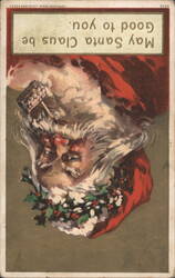 Santa Claus Upside Down with Holly Wreath, 'May Santa Claus be good to you' Postcard