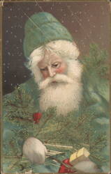 Santa Claus in Green with Evergreen Wreath and Falling Snow Postcard