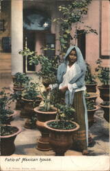 Patio of Mexican house with woman and potted plants Postcard