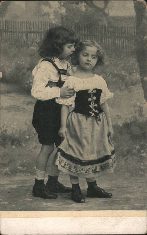Boy Kissing Girl in Traditional European Costumes Children
