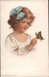 A young girl with curly hair and a blue bow holding a butterfly Postcard