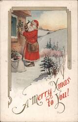 Santa Claus Decorating House with Holly, Snowy Landscape, "A Merry Xmas to You!" Postcard
