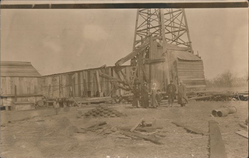 Oil Derrick and Crew/Family Oil Wells