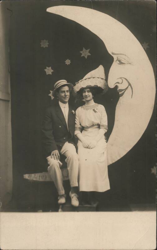 Man & Woman on Crescent Paper Moon Prop with Stars
