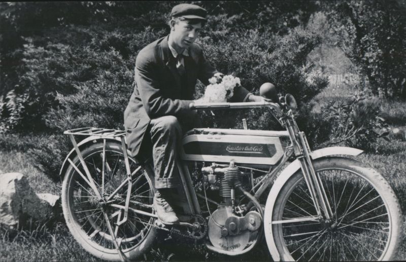 Man on Excelsior Auto-Cycle with Flowers
