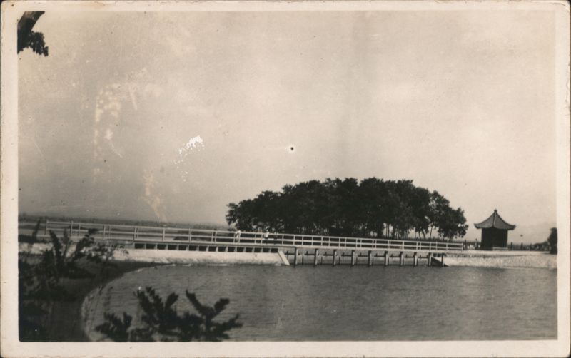 Long Bridge Over Water with Asian-style Pavilion and Trees