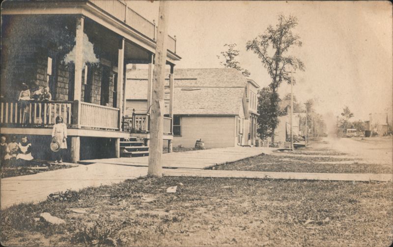 Street Scene with People on Porch and Boardwalk Chatham New York