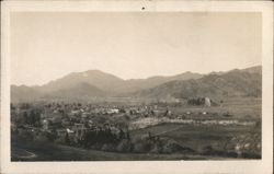 Panoramic View of Valley Town, Mountains, and Fields Postcard