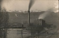 Longmont CO Factory, Smokestack, Snow-Capped Mountains Postcard