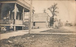 Street Scene with People on Porch and Boardwalk Postcard