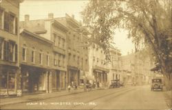 Main Street with Businesses and Early Automobiles Postcard