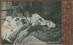 Two Girls in Bed with Christmas Dolls Postcard